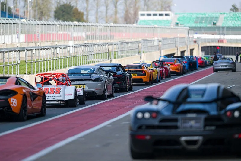 Sports cars waiting in the Silverstone pit lane